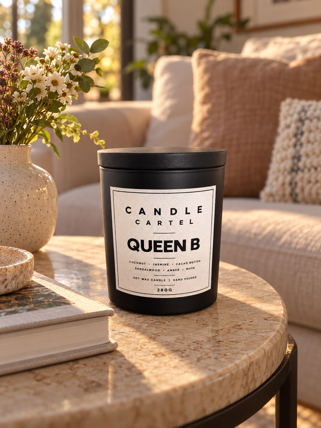 Queen B 280g soy candle by The Candle Cartel in a warm living room